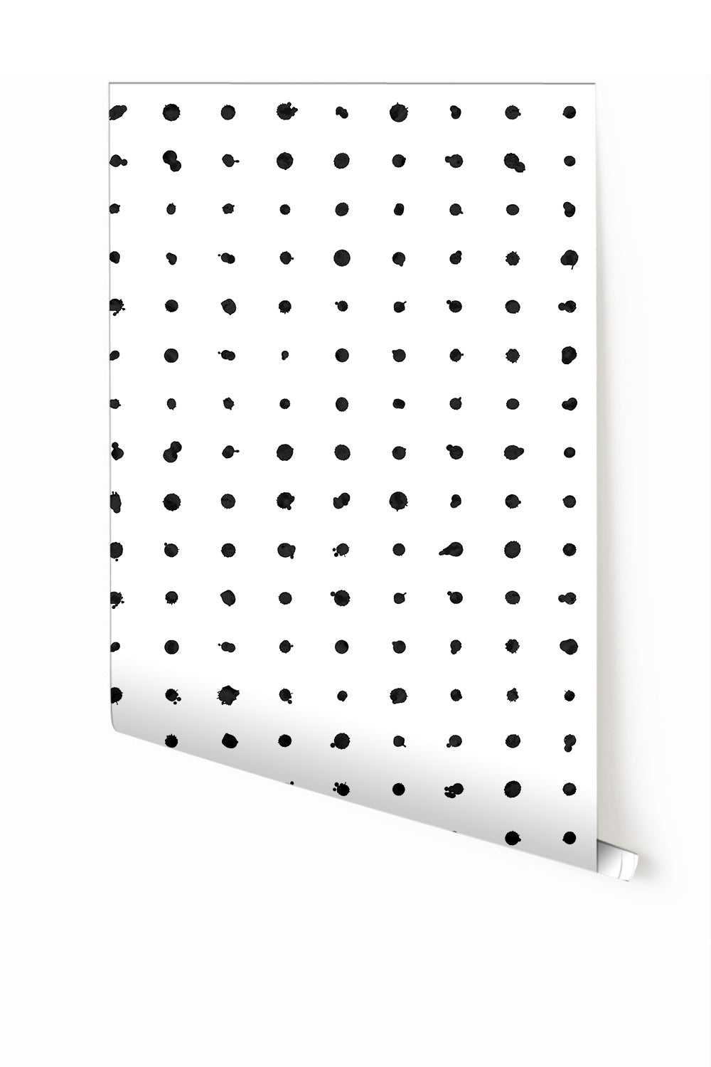 A roll of dotted line wallpaper with a black and white pattern consisting of irregular dots from drop it MODERN.