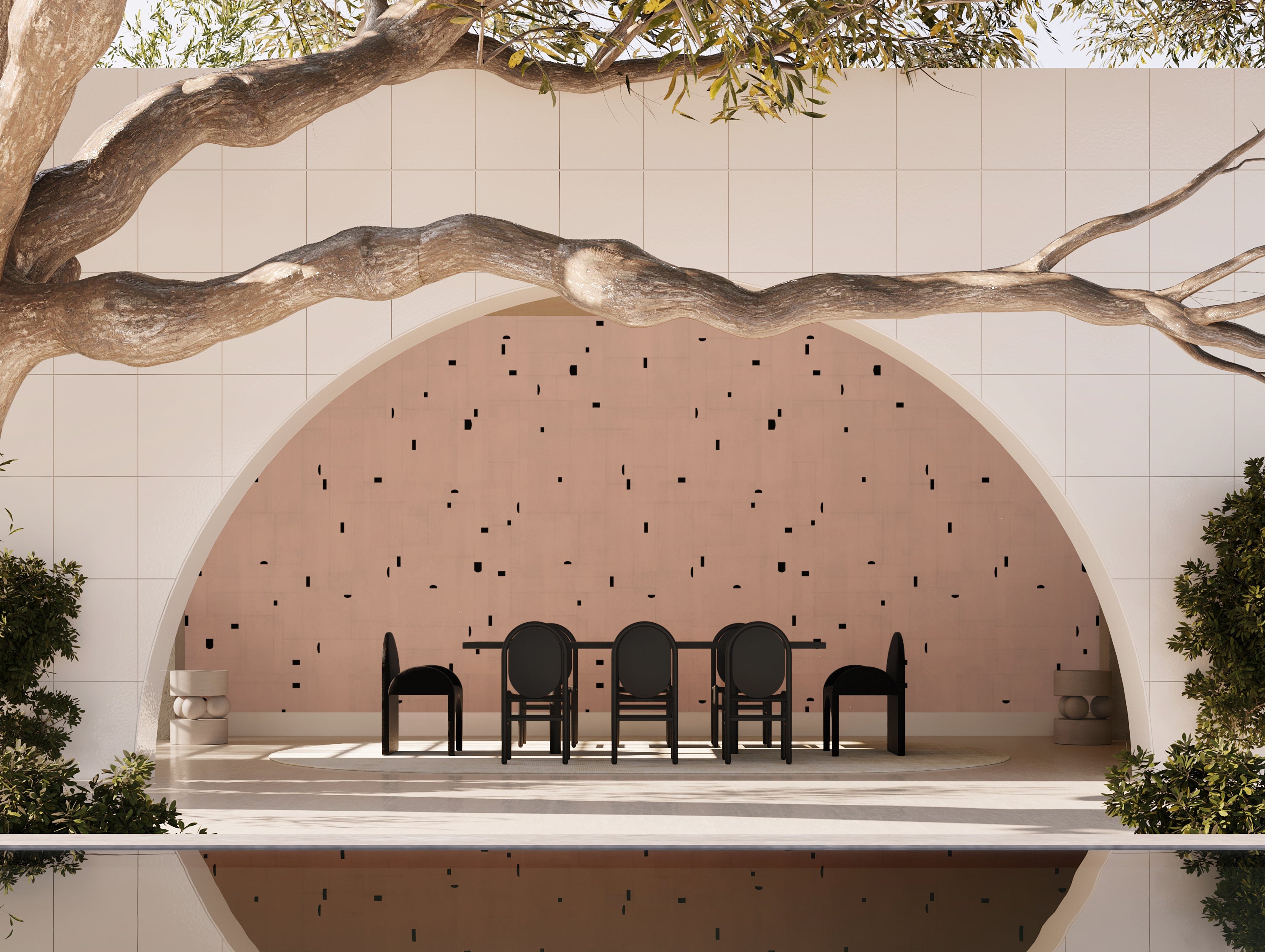 Dining area with chairs and a table inside a circular alcove with a textured pink wall from drop it MODERN.