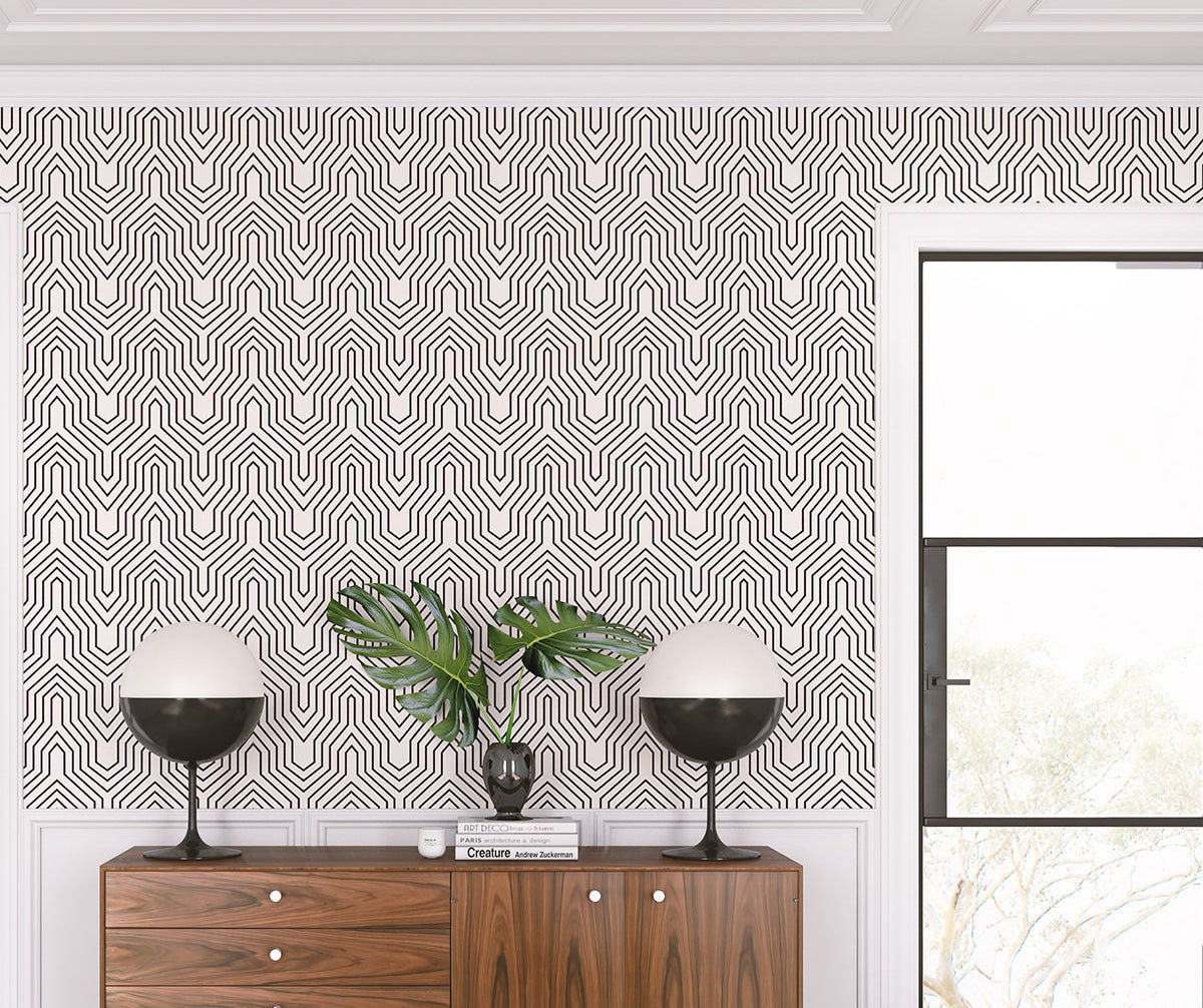 Room interior with geometric patterned wallpaper, wooden cabinet, and decorative items from drop it MODERN.
