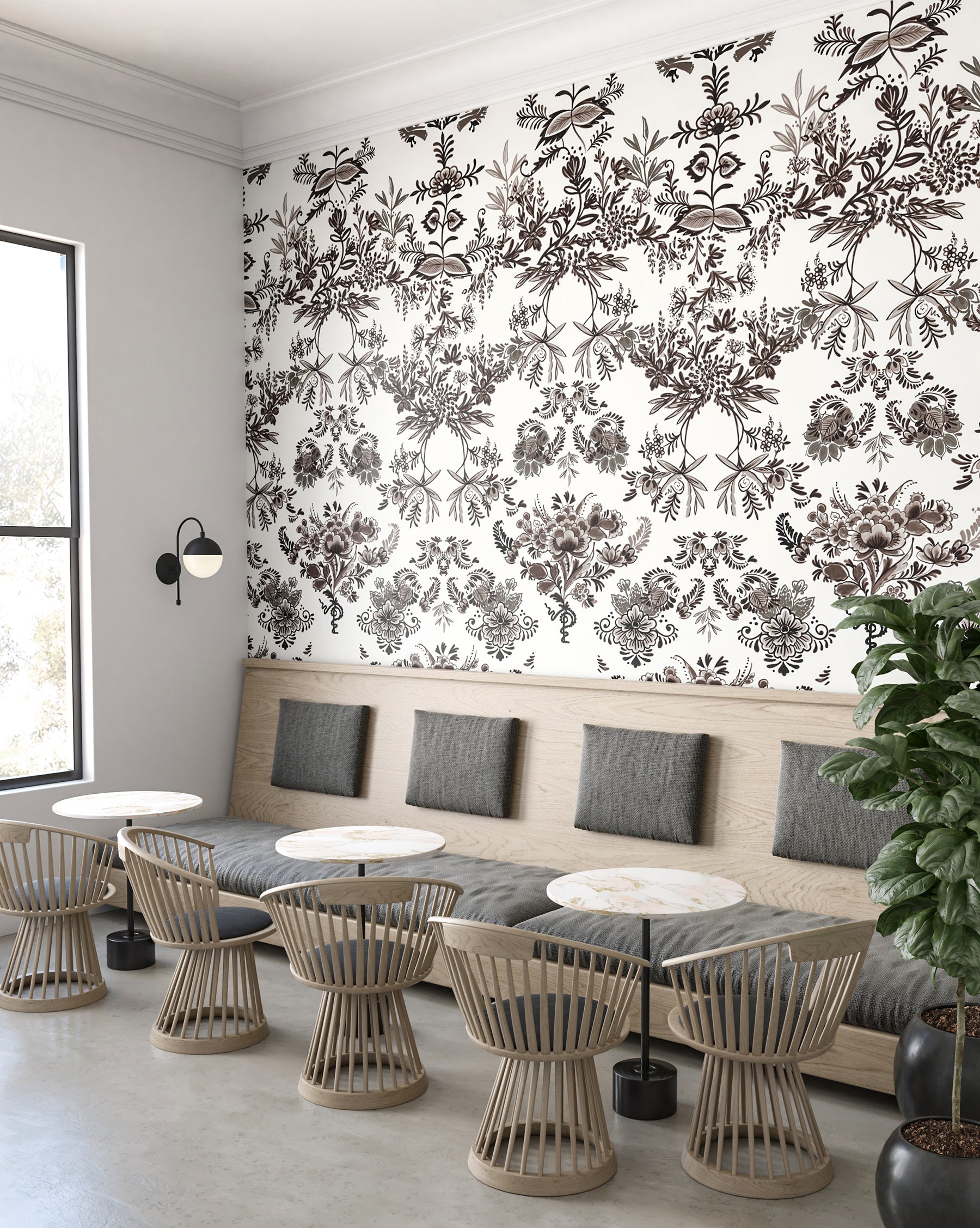 Modern interior with floral wallpaper, gray sofa, and wicker chairs from drop it MODERN.